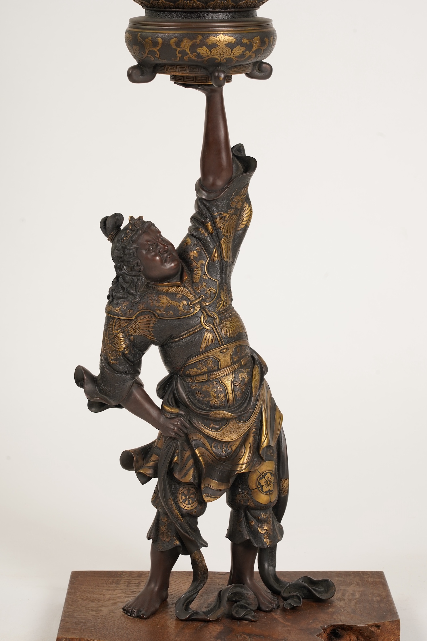 A large Japanese Miyao style parcel gilt bronze figure holding a koro aloft, 20th century
